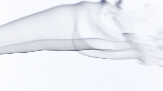 Silky colored smoke flowing in the air on a white background.