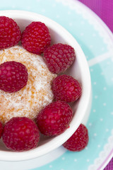 Glazed doughnut with raspberry close up