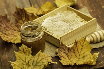 fresh honey and drizzler on a wooden background. Autumn style, honeycomb