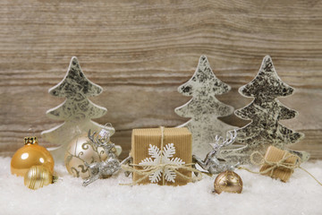 Dekoration zu Weihnachten in gold, silber und braun mit Geschenk