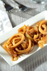 Fried squid rings with onion. Appetizer. © tktyfy
