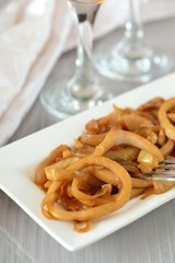 Fried squid rings with onion. Appetizer. © tktyfy