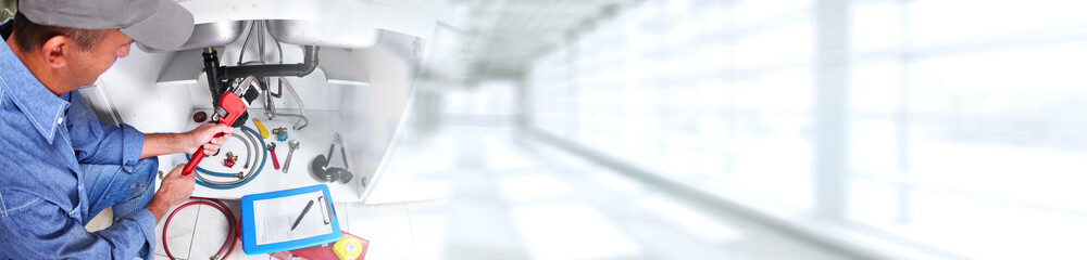 Hand of Plumber with a wrench.