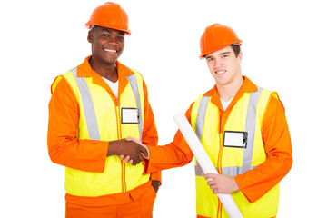 male industrial co-workers handshaking