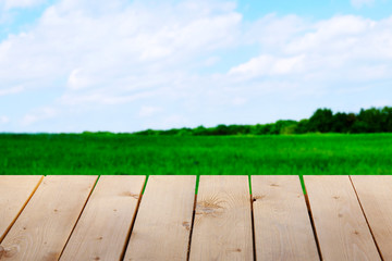 Wooden table with field background