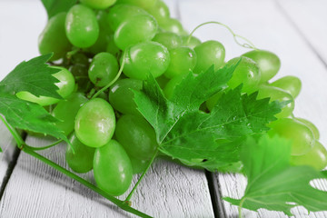 Bunch of white grape on white wooden background