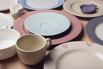 Composition of tableware on rosy background