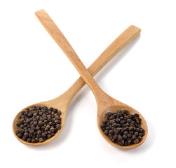 Wooden spoon and peppercorn on white background