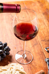 Red wine pouring into glass