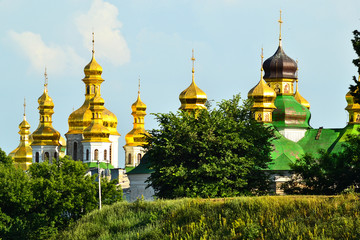 Fototapeta na wymiar Golden and green domes of Kiev Pechersk Lavra churches