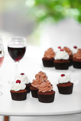 Tasting of wine and chocolate cupcakes, close up