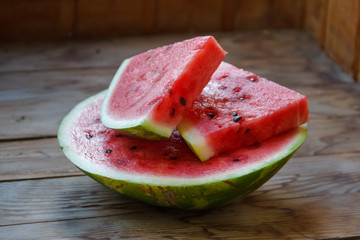 Juicy big red watermelon lying on a wooden table
