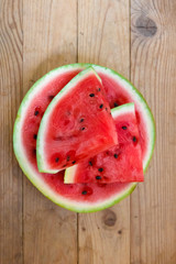 Juicy big red watermelon lying on a wooden table