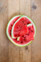 Juicy big red watermelon lying on a wooden table