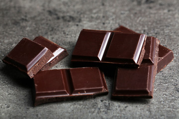 Black chocolate pieces on  dark gray background