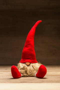 Red christmas tad in front of dark wooden background