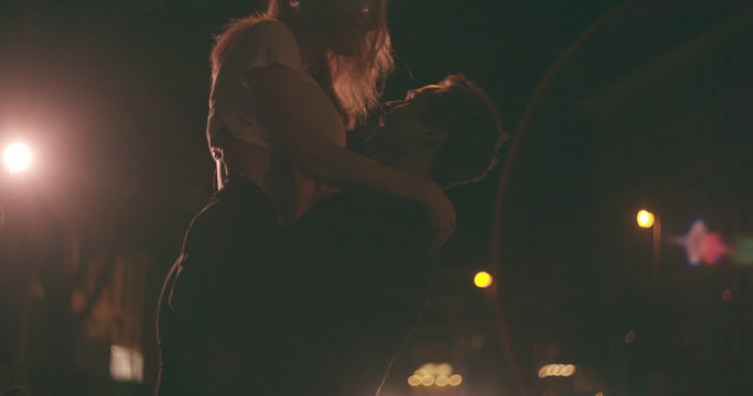 Young couple on a date at night on city street