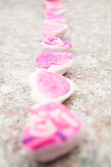 Lineup delicious pink covered cookies with line continuing out