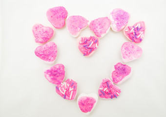 Tasty looking cookies with pink frosting shaped into a heart