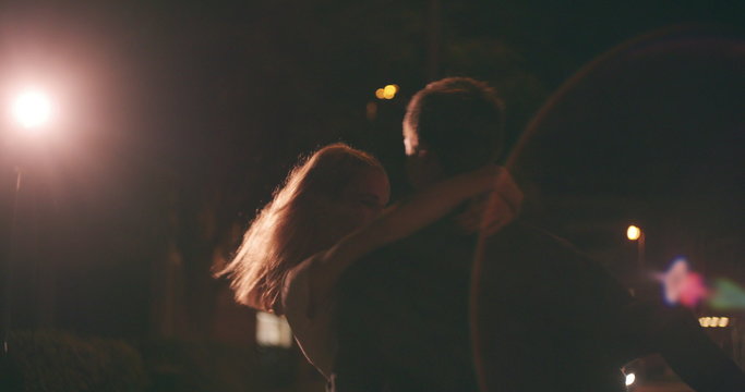 Young couple on a date at night on city street