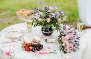 Served table outdoors. Flower arrangement with lavender and