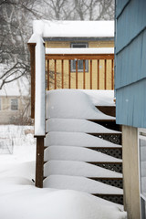 snow covered side stairs after blizzard