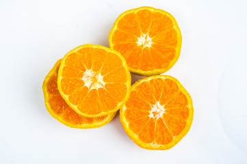 Tasty slice of an orange over a white background