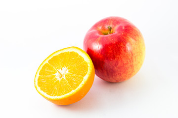 Apple with half orange on white background.