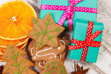 Gingerbread with spices and gifts for Christmas on old wooden background, christmas time