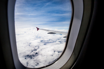 Fototapeta premium View of cloud sky and wing of airplane from window