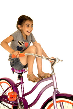 Girl riding bicycle with her legs up smiling funny photo