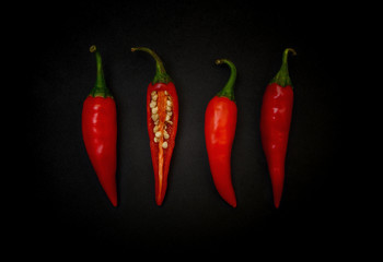 Red chili pepper on black background