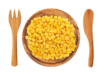 sweet corn grain on wooden plate, fork and knife isolated on whi