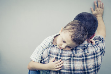 sad son hugging his dad