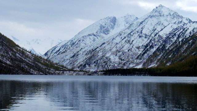 Lower Multinskoe lake in the Altai Mountains in cloudy weather
