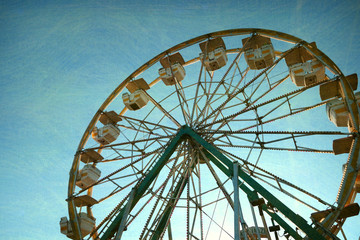 aged and worn retro photo of ferris wheel   