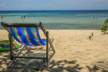 Relaxing beach chair on tropical white sand beach - (Close-up). It's intended to show freedom of lifestyle.