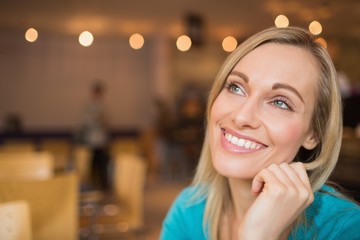 Close-up of happy thoughtful young woman