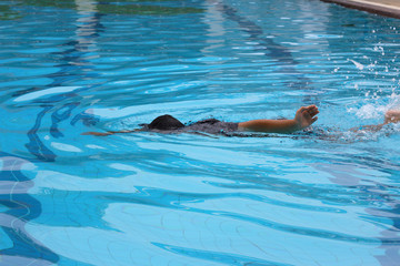 Obraz premium Swimming lessons / A kid learning his swimming lessons in action