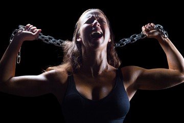 Aggressive female athlete holding chain