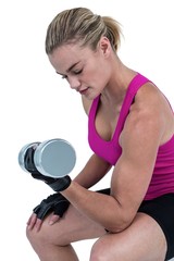 Fototapeta na wymiar Muscular woman exercising with dumbbells 