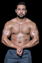 Fototapeta na wymiar Portrait of a bodybuilder man flexing muscles