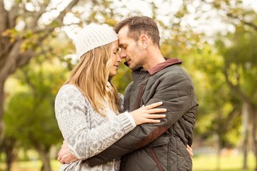 Portrait of smiling young couple embracing