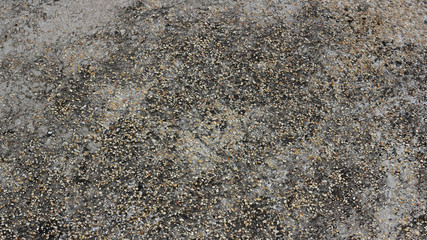 Concrete floor / A concrete floor with small rocks mixed  