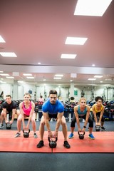 Fototapeta na wymiar Fit people working out in fitness class