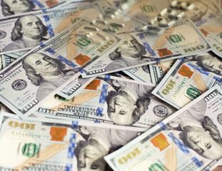 Collage with a pile of one hundred US dollar bills and credit card