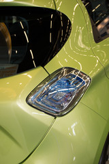 Green  electric Car - a back side, half.