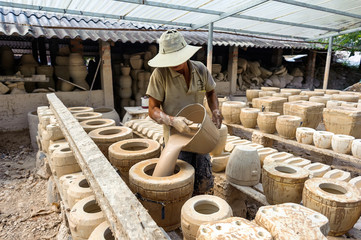 A man working on pottery kilns, Binh Duong province, Vietnam.