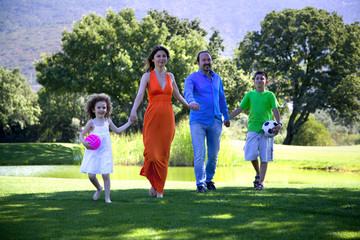 Happy family is enjoying at park on a weekend day all together