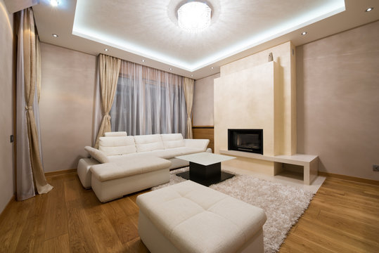 Interior of a specious living room with fireplace and luxury cei